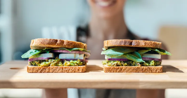 Woman planning 16:8 intermittent fasting meals with healthy ingredients and meal prep containers for optimal nutrition