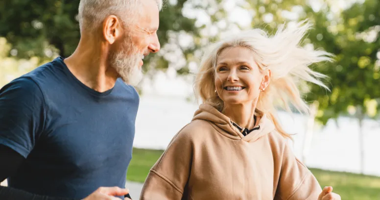 Two friends jogging together demonstrating how exercise can trigger autophagy and cellular renewal processes