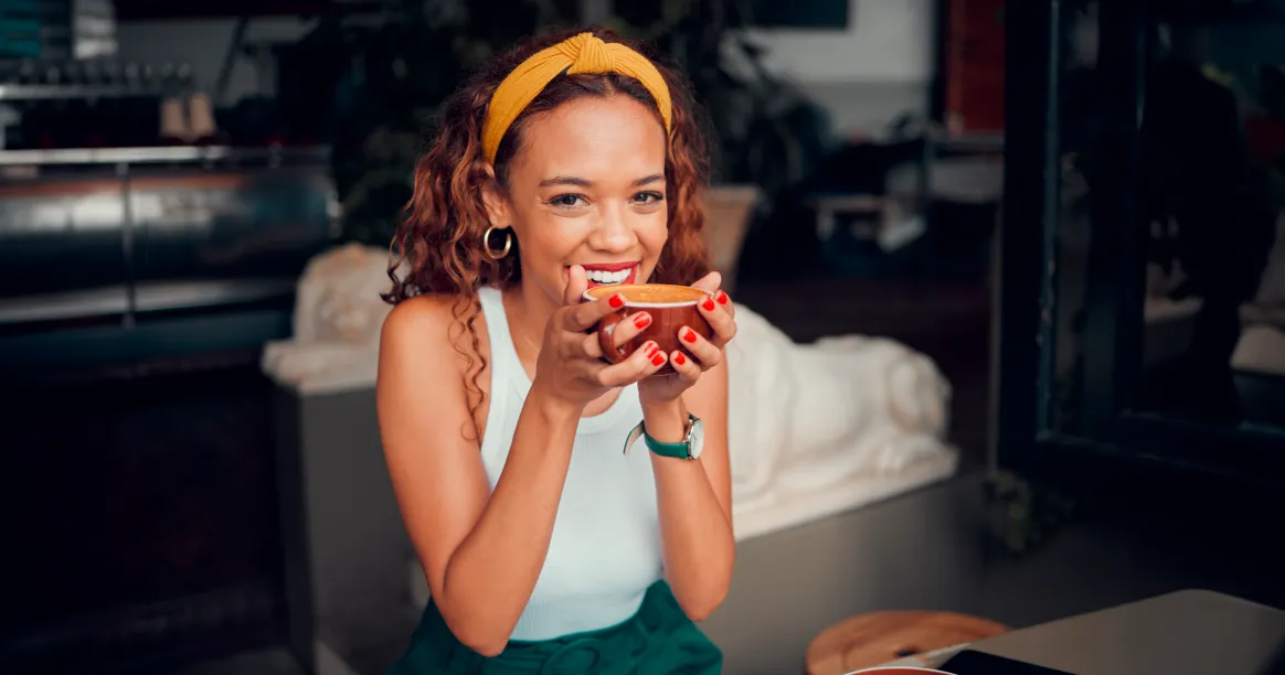 Woman enjoying bulletproof coffee while planning her intermittent fasting schedule