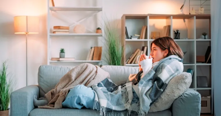 Woman feeling cold during intermittent fasting with temperature regulation tips and warm clothing