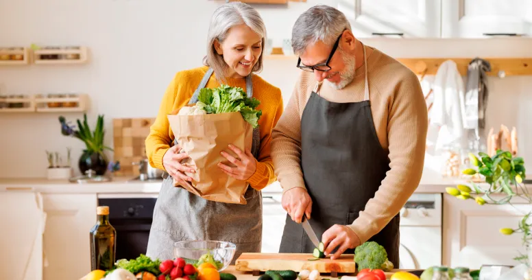 Couple planning vegan intermittent fasting meal schedule with healthy plant-based ingredients