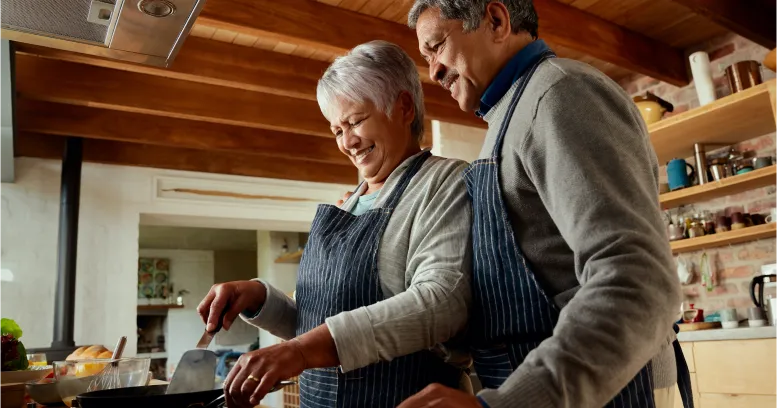 Couple cooking vegetarian meals together while starting intermittent fasting lifestyle