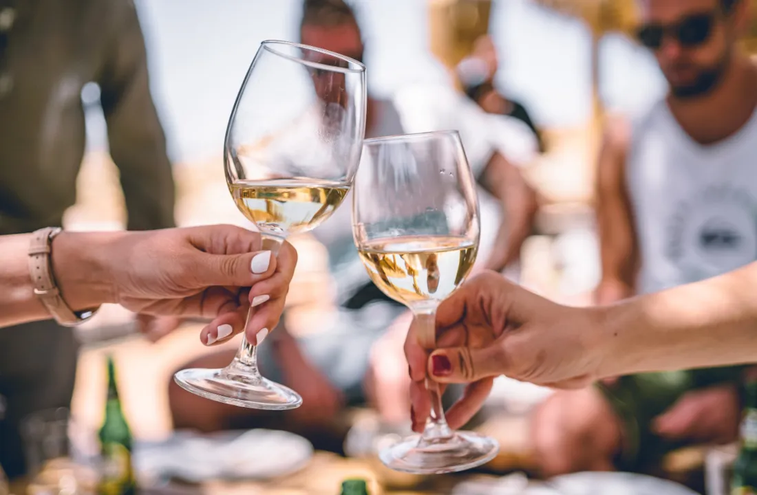 People enjoying drinks and socializing while considering intermittent fasting and alcohol consumption