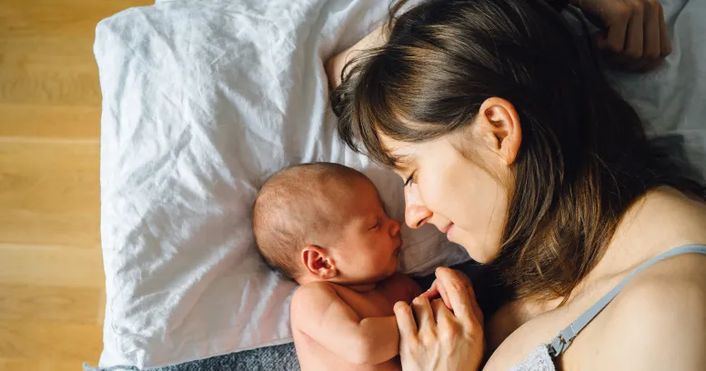 Postpartum woman embracing body changes and recovery journey after pregnancy
