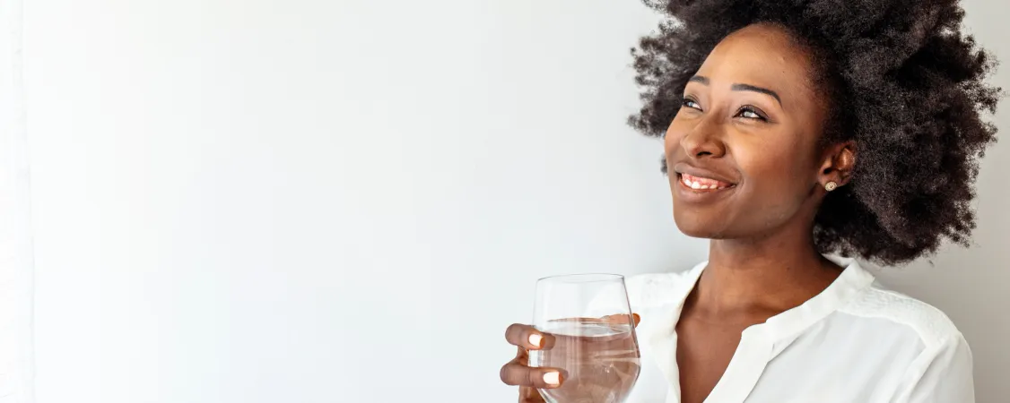 Woman drinking water staying hydrated during intermittent fasting for optimal results