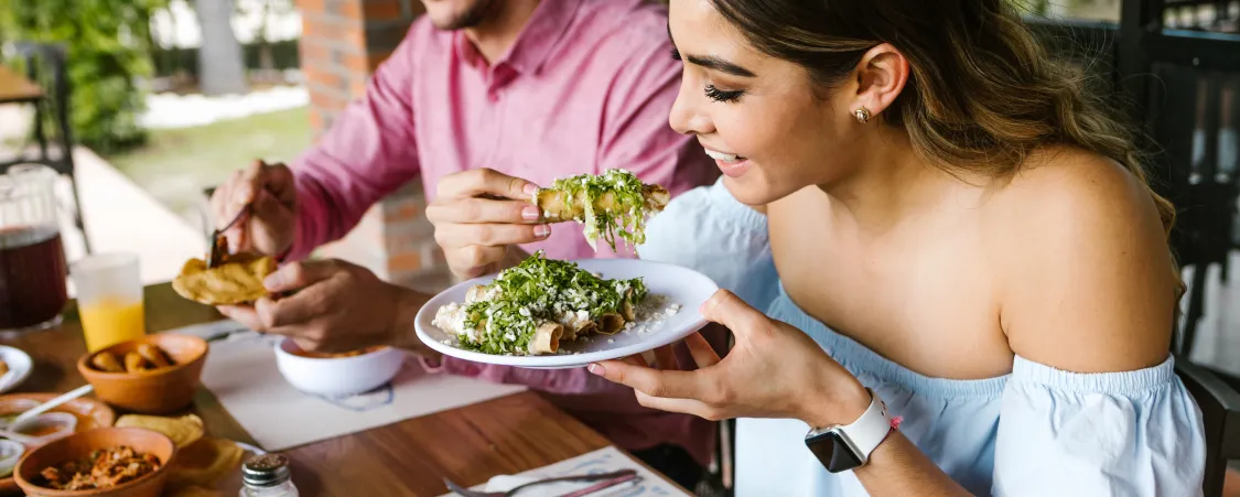 Friends enjoying meal together while maintaining intermittent fasting eating window schedule with flexible food choices